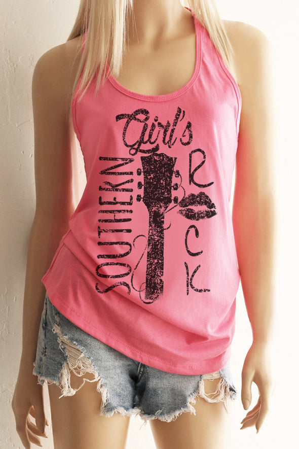 A blonde model wearing shorts and a pink racerback tank top with a black design with the words Southern Girl's Rock with  a guitar neck and strings in the middle. 