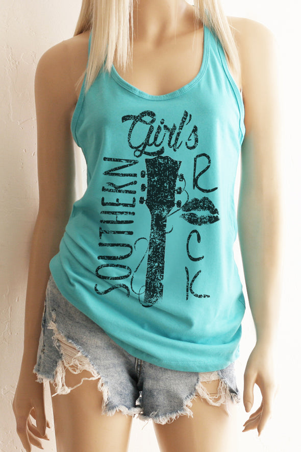 A blonde model wearing shorts and a Tahiti blue racerback tank top with a black design with the words Southern Girl's Rock with  a guitar neck and strings in the middle. 